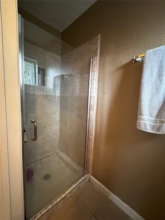 a bathroom with a glass shower door