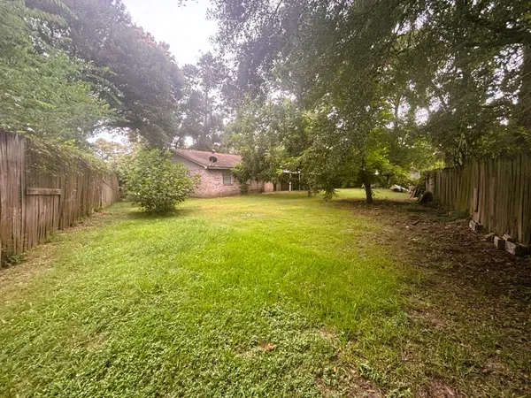 a view of a field with trees in front of it