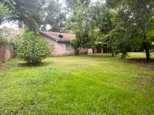 a backyard of a house with table and chairs
