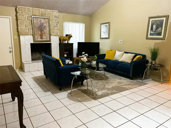 a living room with furniture and a fireplace