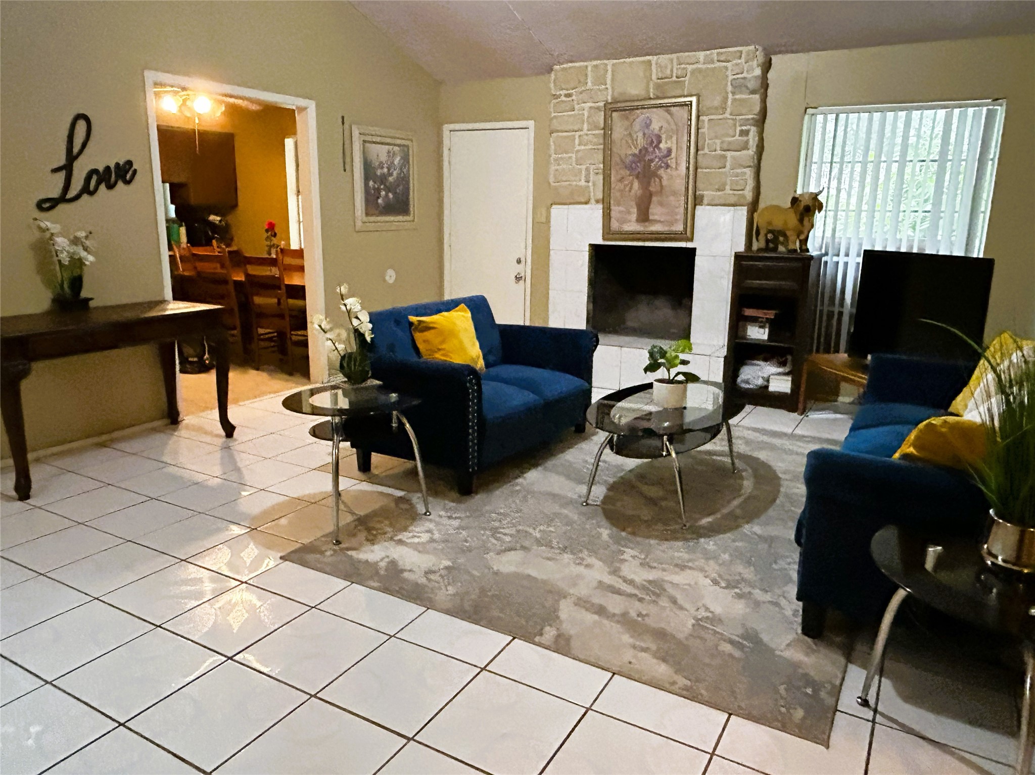 4330 Tylergate Drive Spring, TX 77373 - Photo 7 of 25 a living room with furniture a fireplace and a flat screen tv
