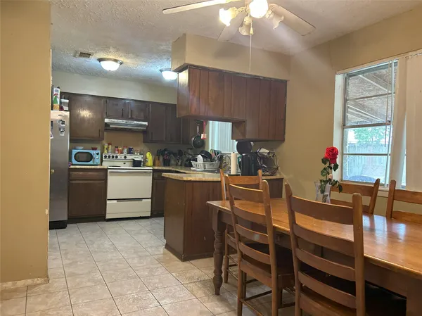 a kitchen with a sink a counter top space and stainless steel appliances