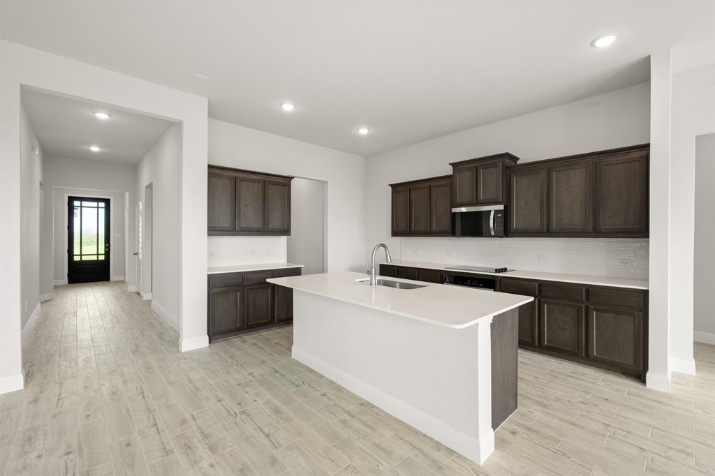 228 Shepards Street Godley, TX 76044 - Photo 4 of 27 a kitchen with stainless steel appliances a stove top oven a sink dishwasher and a refrigerator with wooden floor