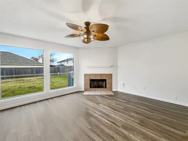 a view of an empty room with a fireplace and a large window