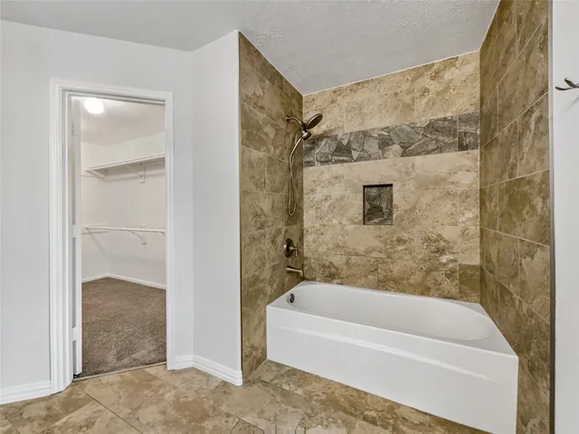 a bathroom with a bathtub and a shower