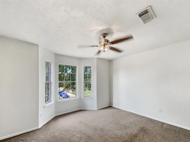 an empty room with windows and closet