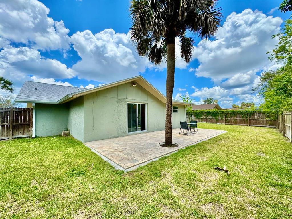 4282 Rudder Way New Port Richey, FL 34652 - Photo 34 of 34 a backyard of a house with table and chairs