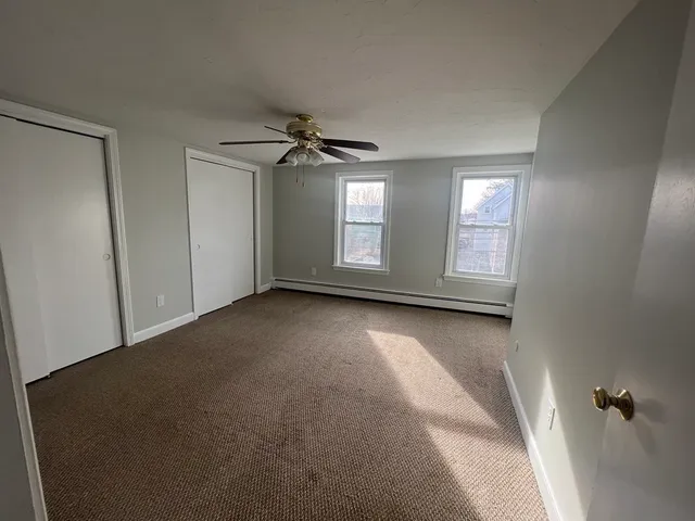 an empty room with windows and closet
