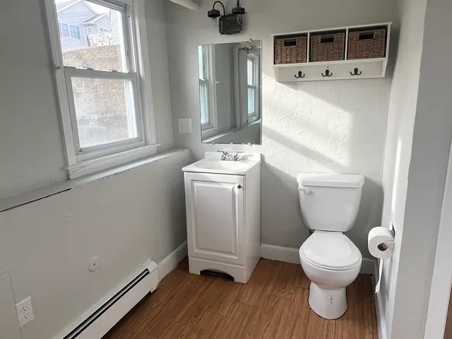 a bathroom with a toilet sink and mirror