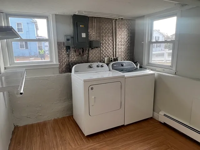 a view of washer and dryer with wooden floor