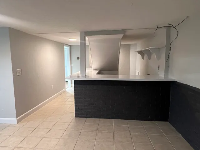 a kitchen with kitchen island sink and faucet