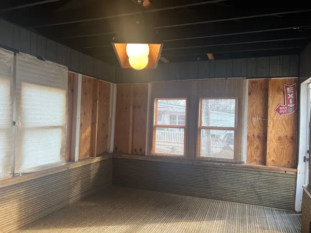 a view of a white house with swimming pool in front of it