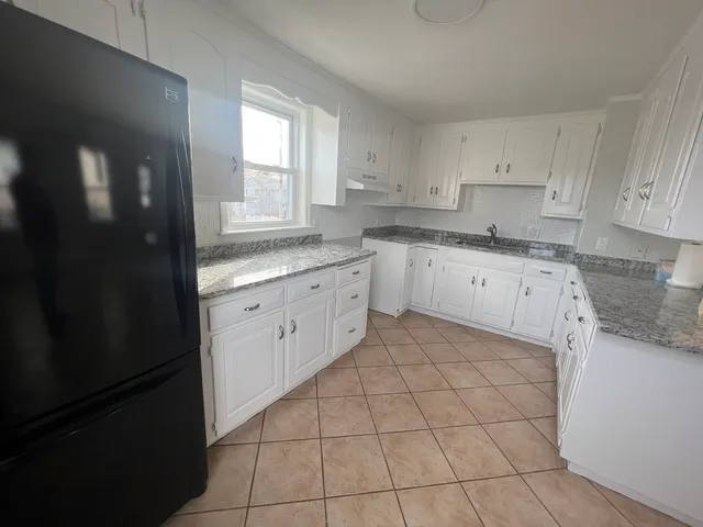 a kitchen with a stove a sink and a refrigerator