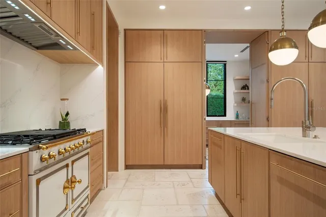 a kitchen with stainless steel appliances granite countertop a sink and a stove