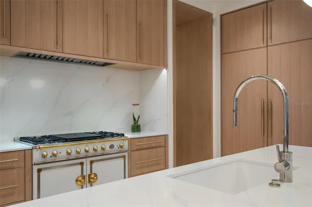 a kitchen with a stove and a white cabinet