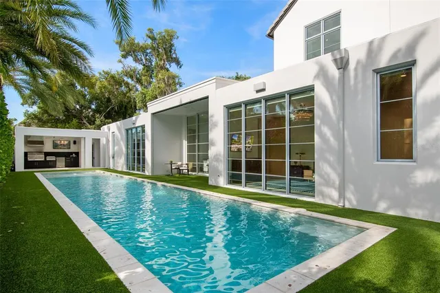 a bathroom with a sink a large mirror and a shower