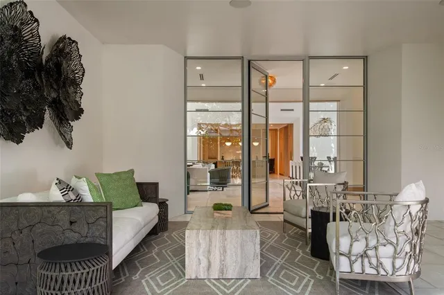 a living room with furniture and a floor to ceiling window
