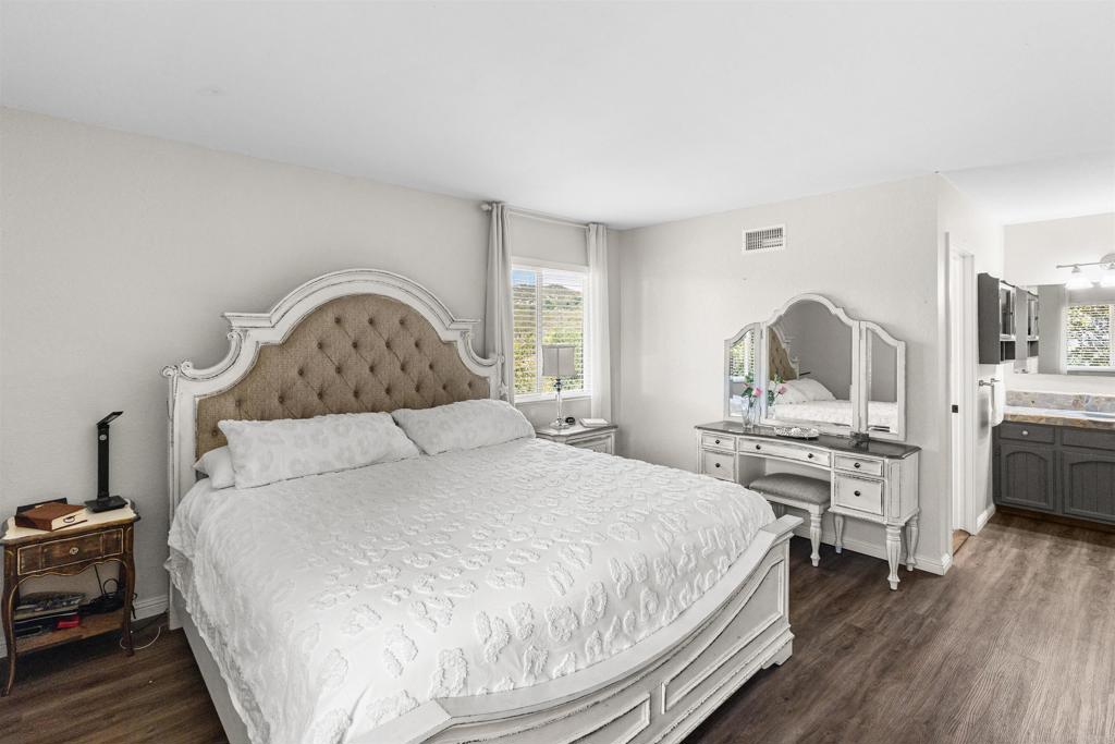 3340 Skytrail Ranch Road Jamul, CA 91935 - Photo 15 of 38 a bedroom with a bed and wooden floor
