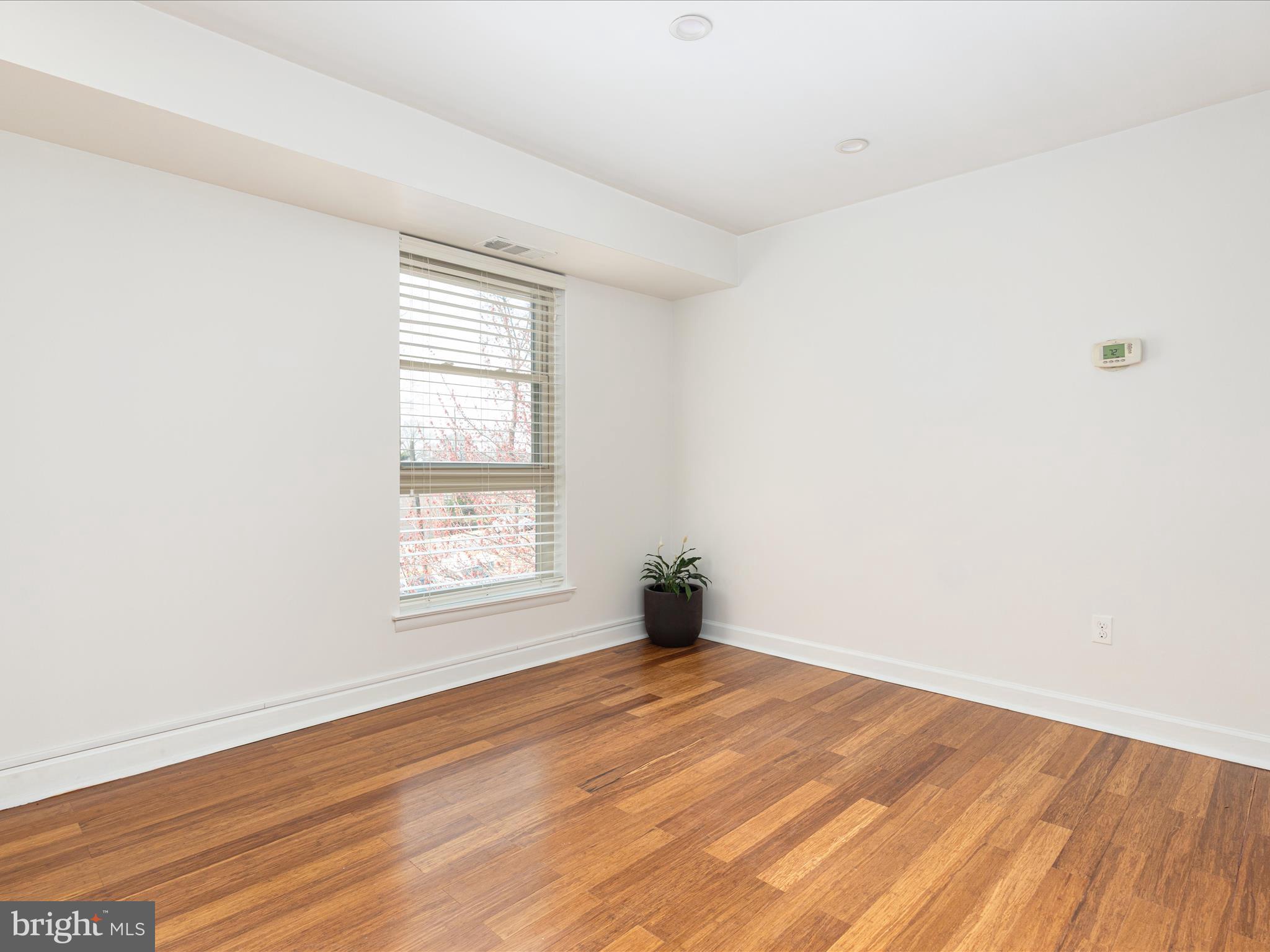 2303 Greenery Lane, Unit 2034 Silver Spring, MD 20906 - Photo 11 of 30 an empty room with wooden floor and window