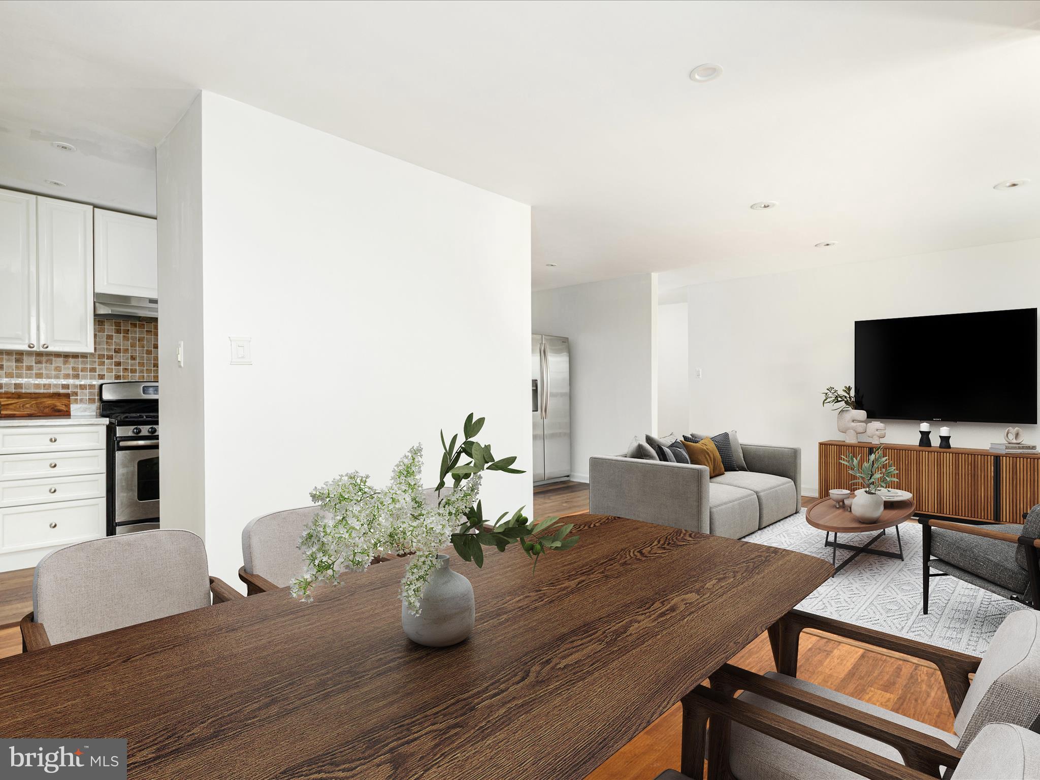 2303 Greenery Lane, Unit 2034 Silver Spring, MD 20906 - Photo 12 of 30 a living room with furniture and a flat screen tv