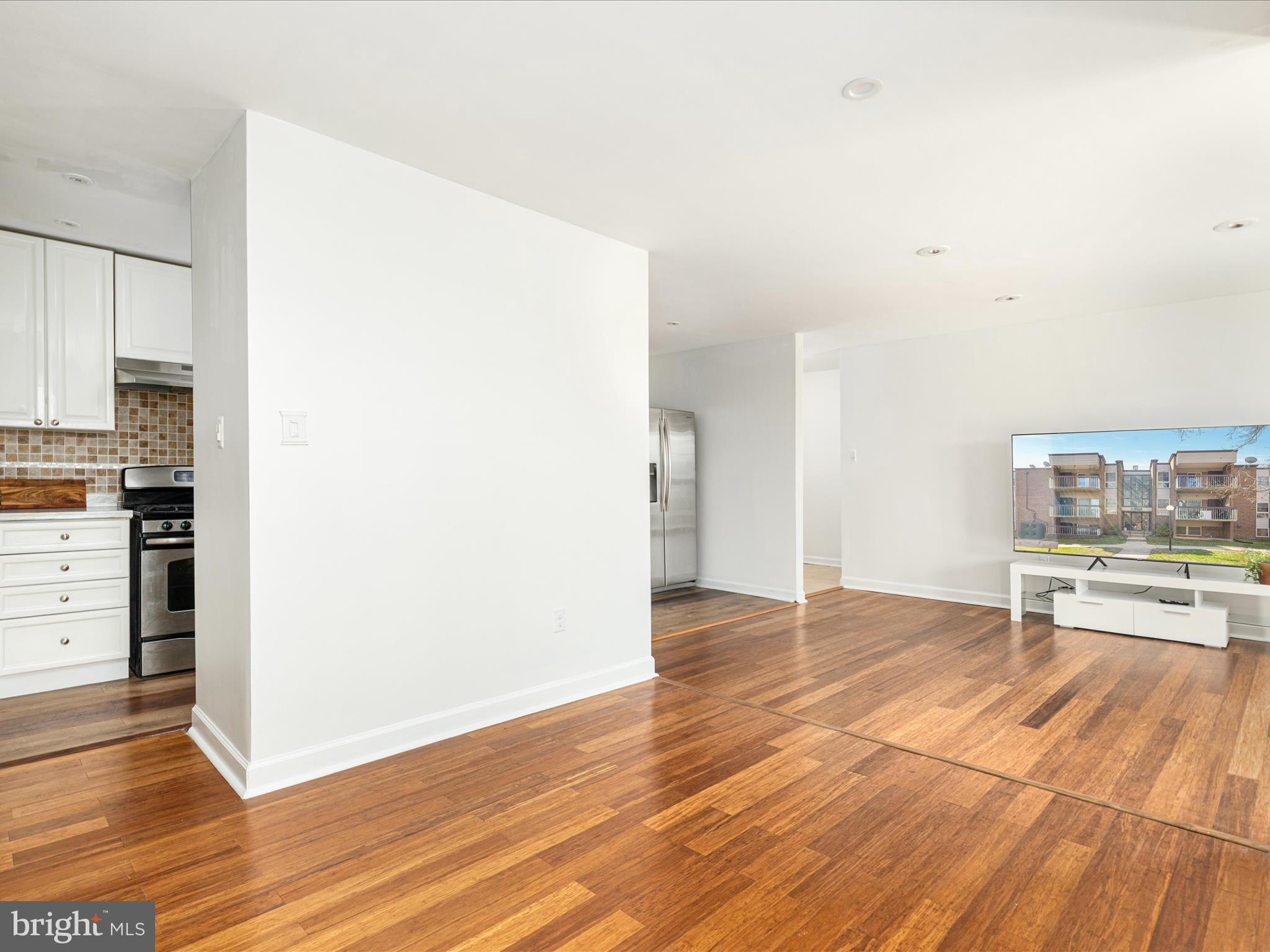 2303 Greenery Lane, Unit 2034 Silver Spring, MD 20906 - Photo 13 of 30 a view of a kitchen with wooden floor and a refrigerator