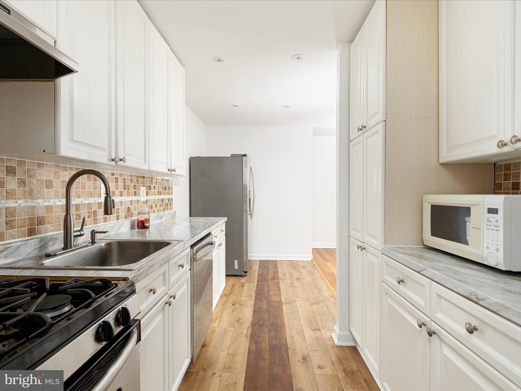 2303 Greenery Lane, Unit 2034 Silver Spring, MD 20906 - Photo 14 of 30 a kitchen with a sink stove and refrigerator
