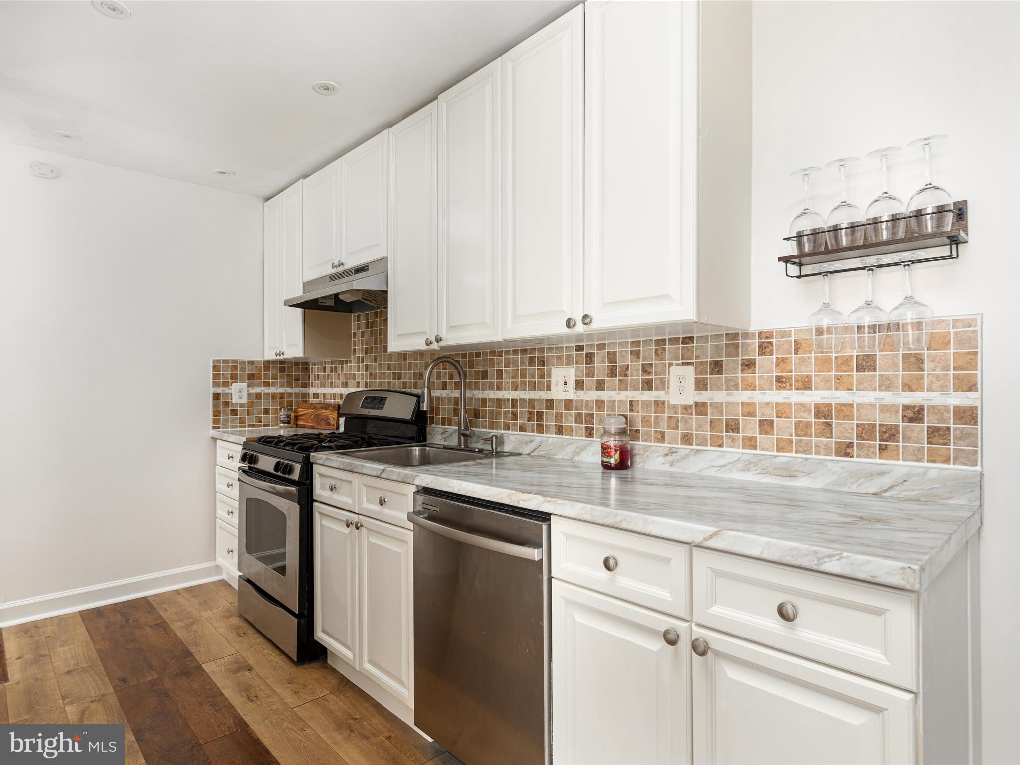 2303 Greenery Lane, Unit 2034 Silver Spring, MD 20906 - Photo 15 of 30 a kitchen with stainless steel appliances granite countertop a sink stove and cabinets