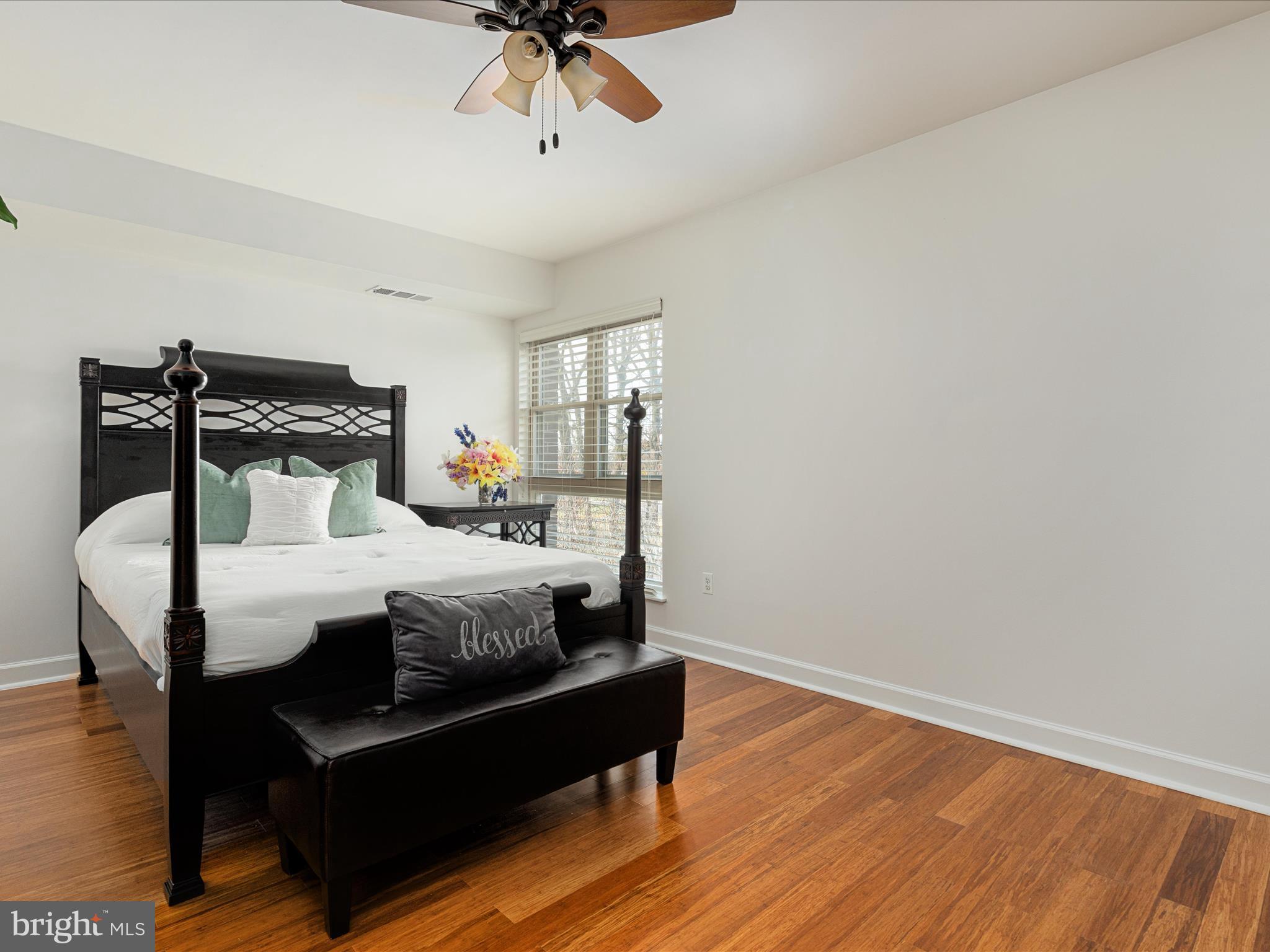 2303 Greenery Lane, Unit 2034 Silver Spring, MD 20906 - Photo 19 of 30 a bedroom with a bed a chandelier and closet