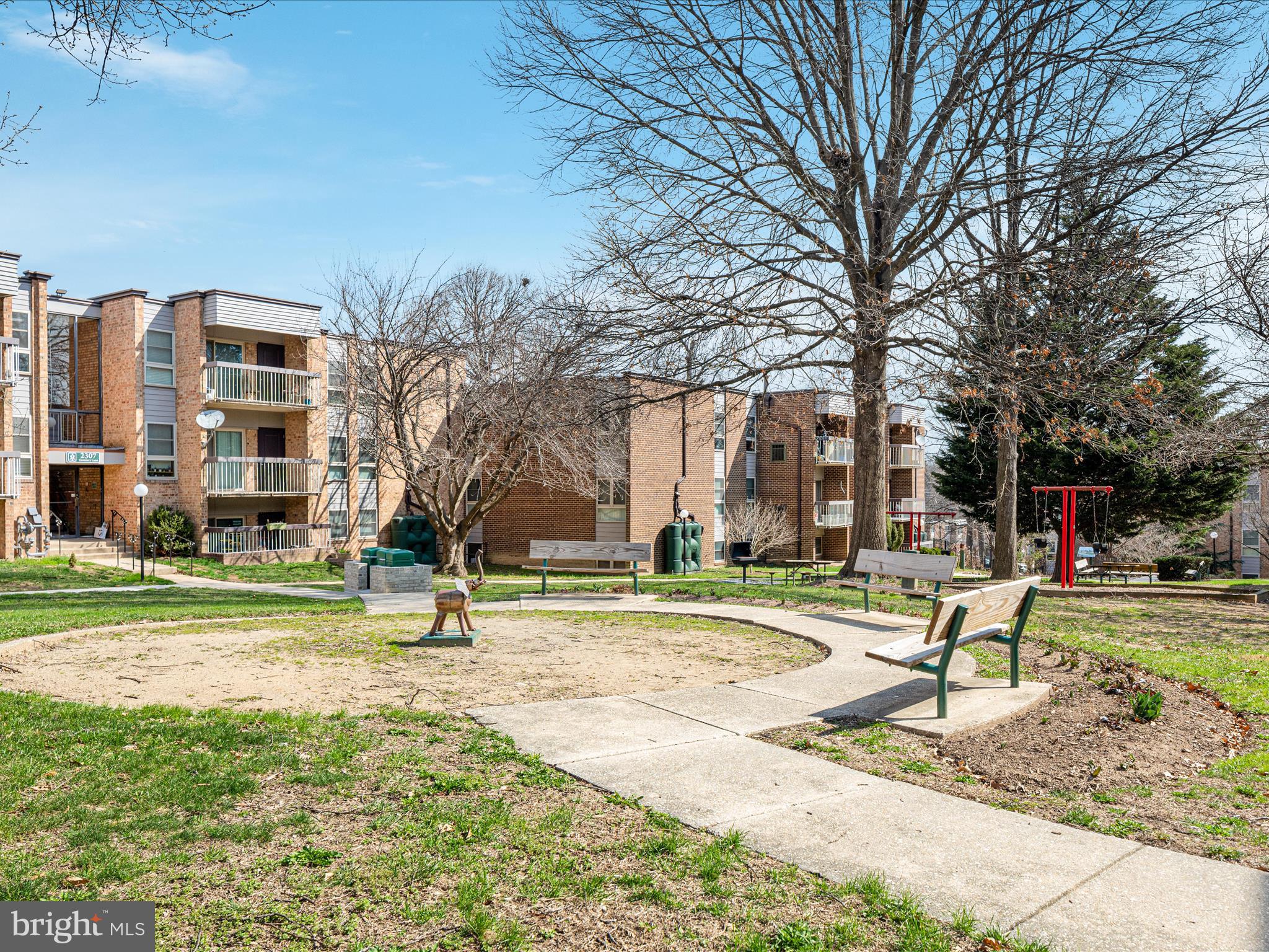 2303 Greenery Lane, Unit 2034 Silver Spring, MD 20906 - Photo 26 of 30 a view of a park with swings and slides