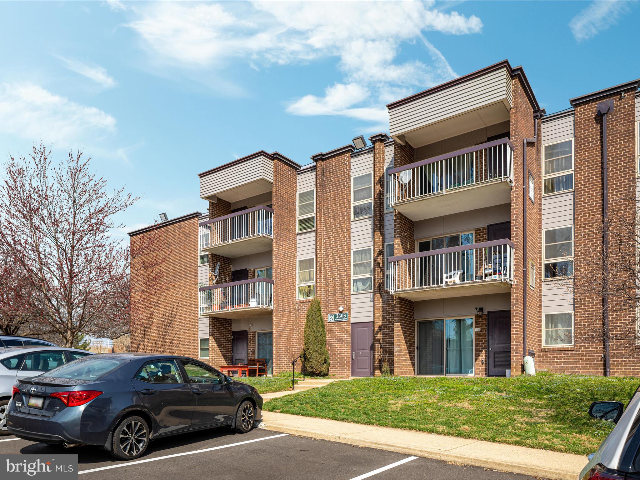 2303 Greenery Lane, Unit 2034 Silver Spring, MD 20906 - Photo 29 of 30 a front view of a residential apartment building with a yard