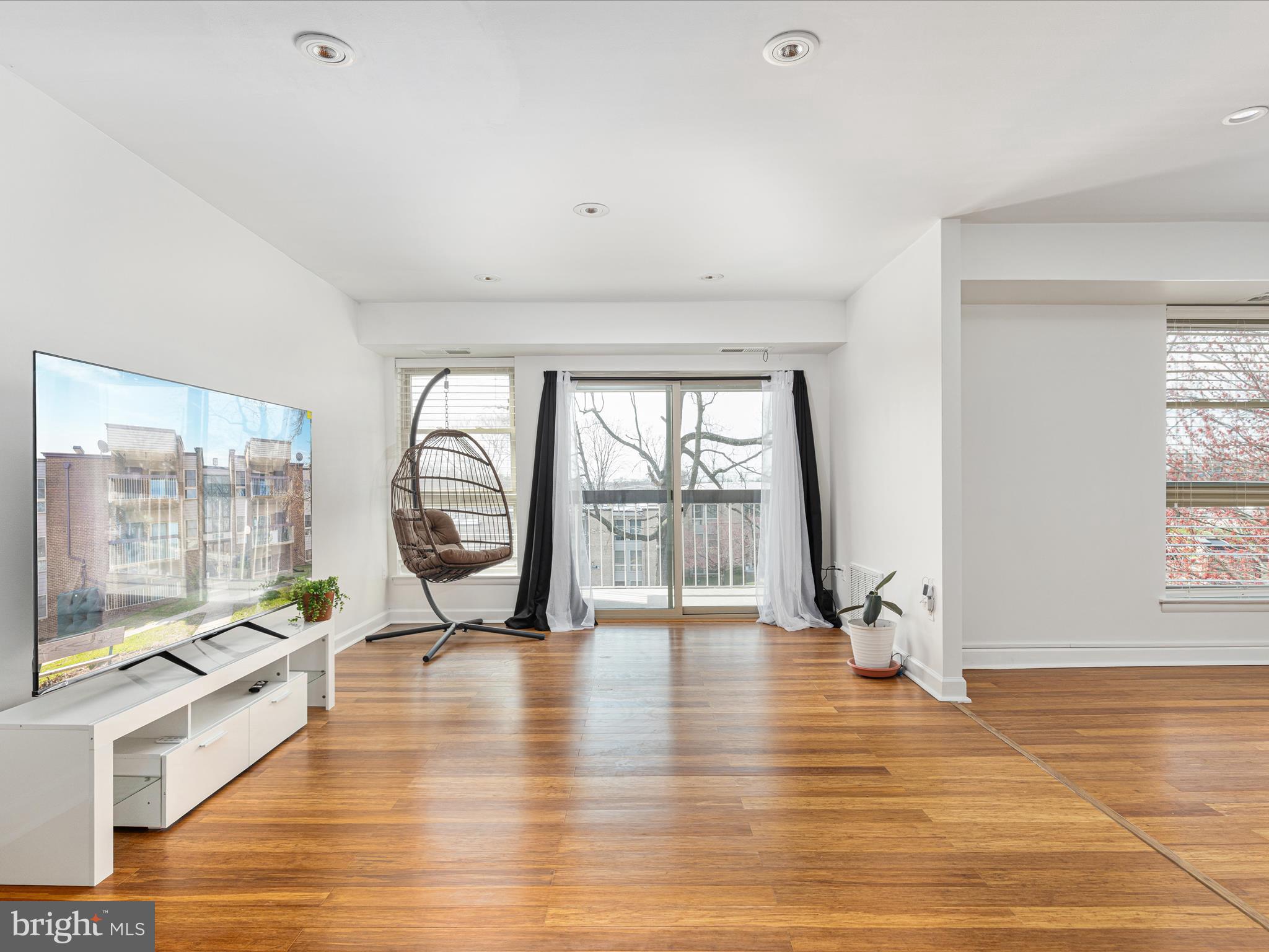 2303 Greenery Lane, Unit 2034 Silver Spring, MD 20906 - Photo 4 of 30 a view of an empty room with wooden floor and a window