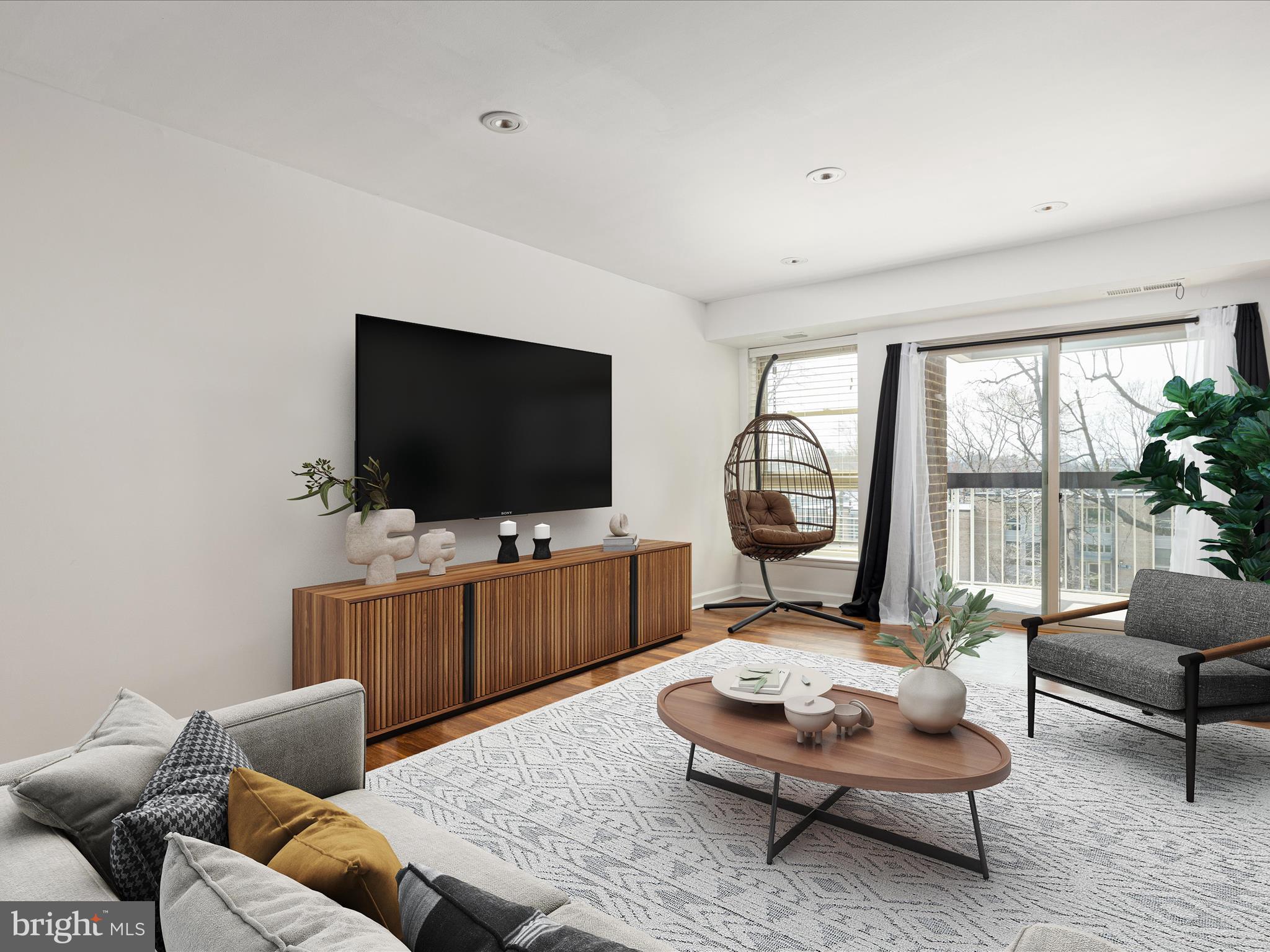 2303 Greenery Lane, Unit 2034 Silver Spring, MD 20906 - Photo 5 of 30 a living room with furniture and a flat screen tv