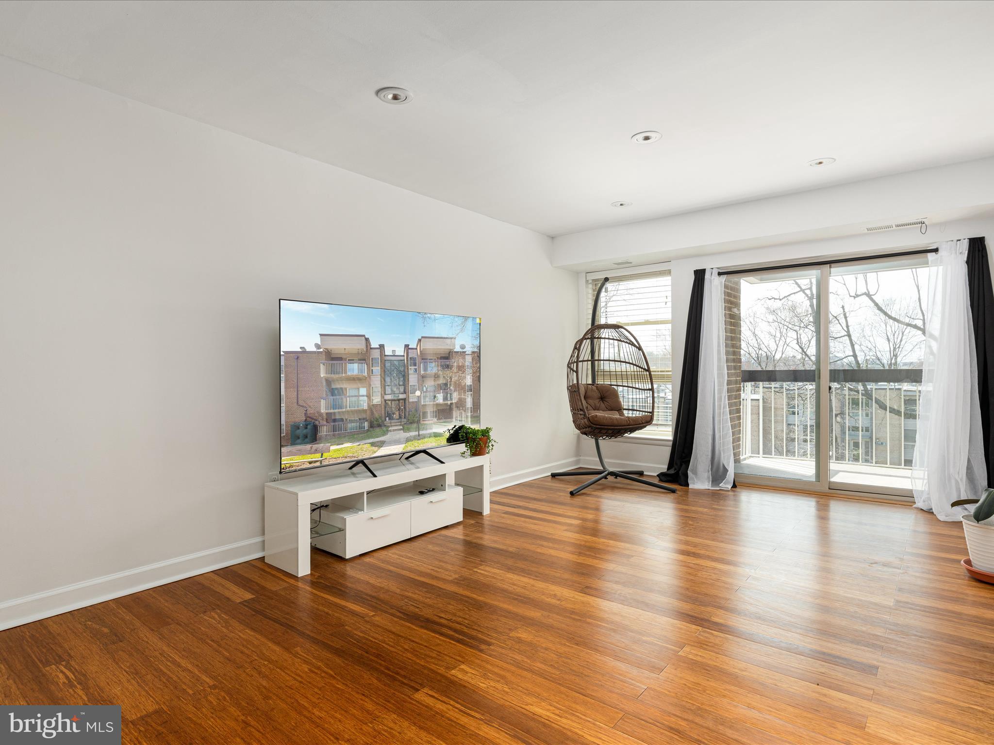 2303 Greenery Lane, Unit 2034 Silver Spring, MD 20906 - Photo 6 of 30 a view of an empty room with a window and wooden floor