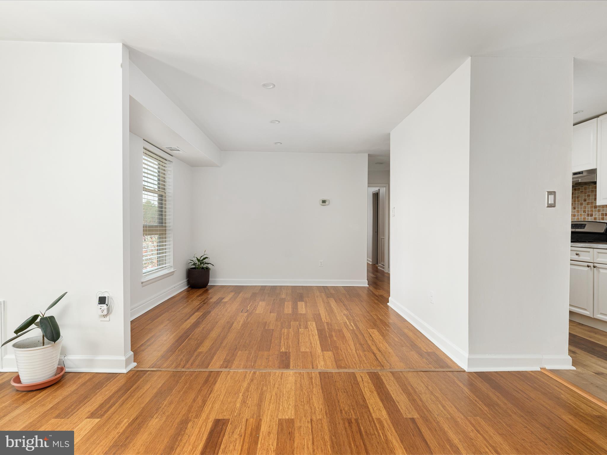 2303 Greenery Lane, Unit 2034 Silver Spring, MD 20906 - Photo 8 of 30 a view of an empty room with wooden floor and a window