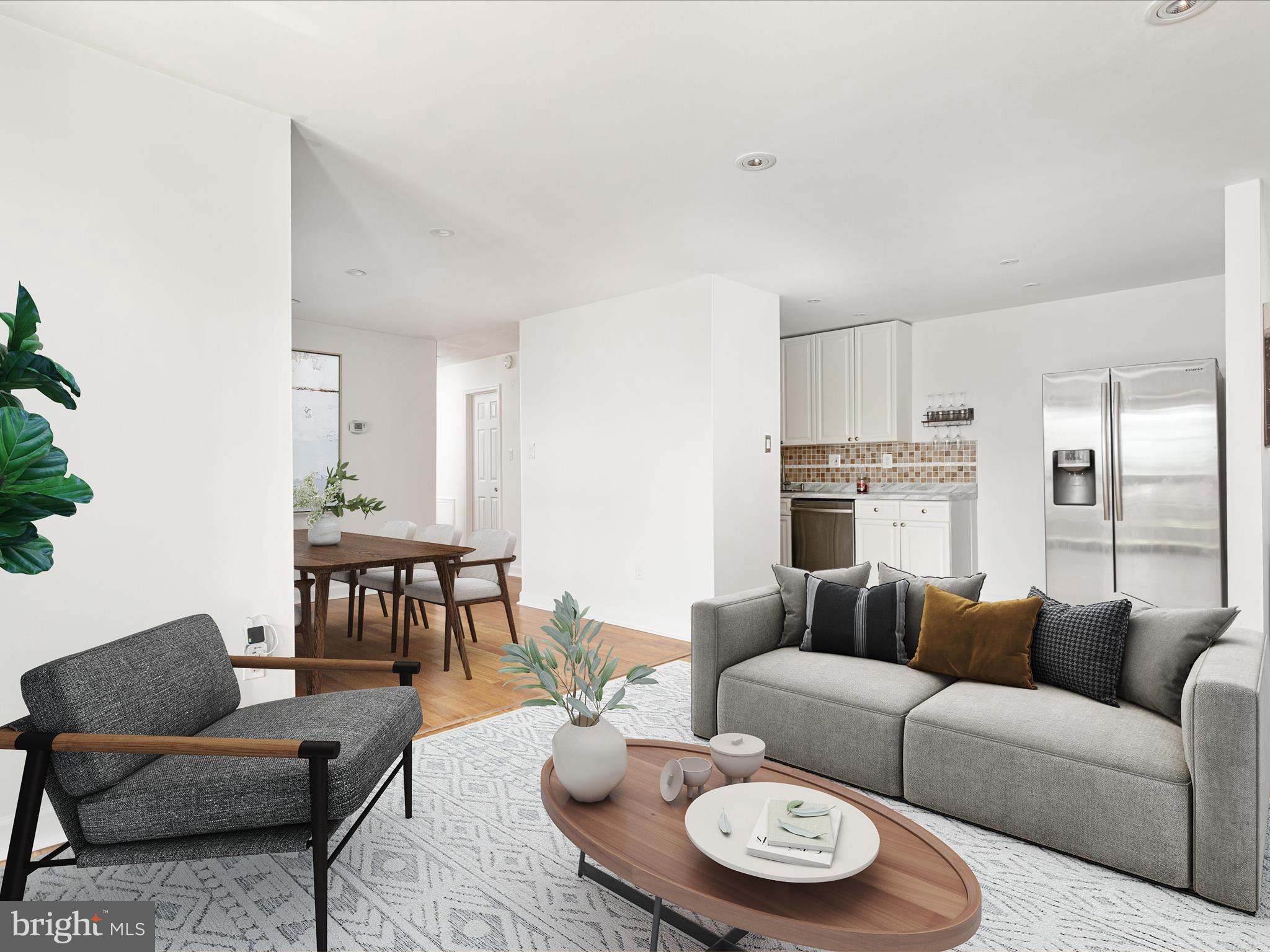 2303 Greenery Lane, Unit 2034 Silver Spring, MD 20906 - Photo 9 of 30 a living room with furniture and a dining table with kitchen view