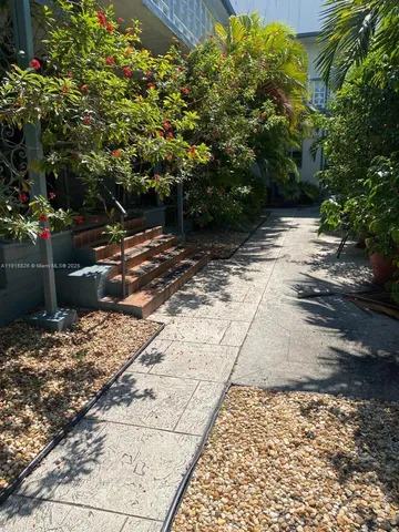 a view of a pathway with a yard