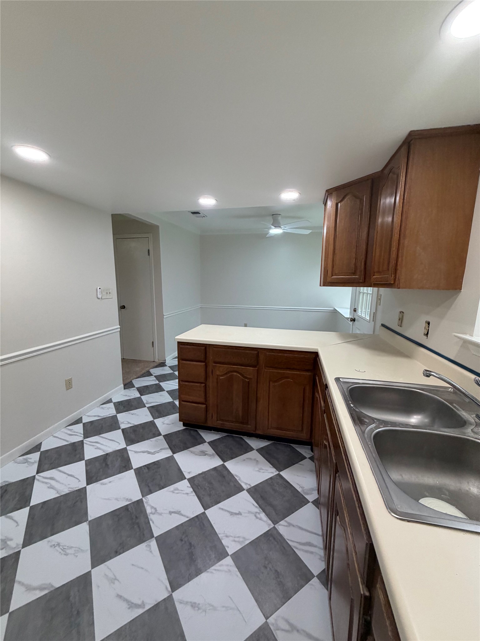 214 The Forest Road Dale, TX 78616 - Photo 8 of 18 Bold checkered flooring defines this well-lit kitchen space.