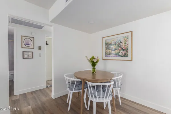 a dining room with furniture and wooden floor