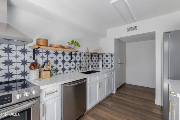 a kitchen with stainless steel appliances granite countertop a sink and cabinets