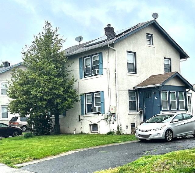 10 Romney Road Bound Brook, NJ 08805 - Photo 1 of 14 a view of a white house in front of a yard with plants and large tree