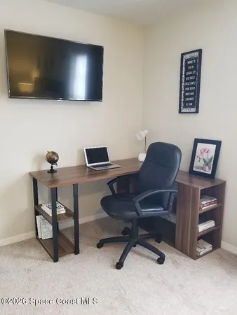 a workspace with furniture and a flat screen tv