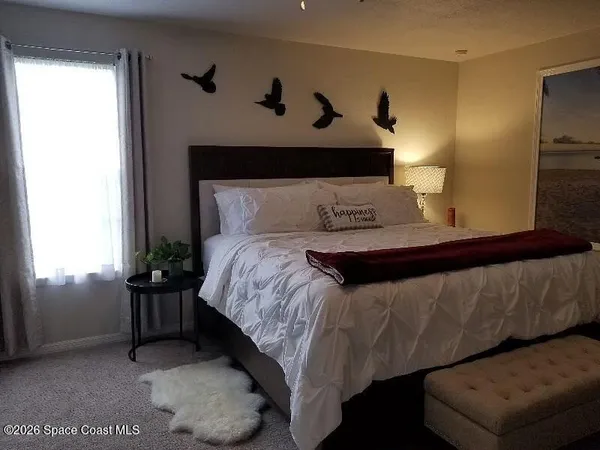 a bedroom with a bed and window