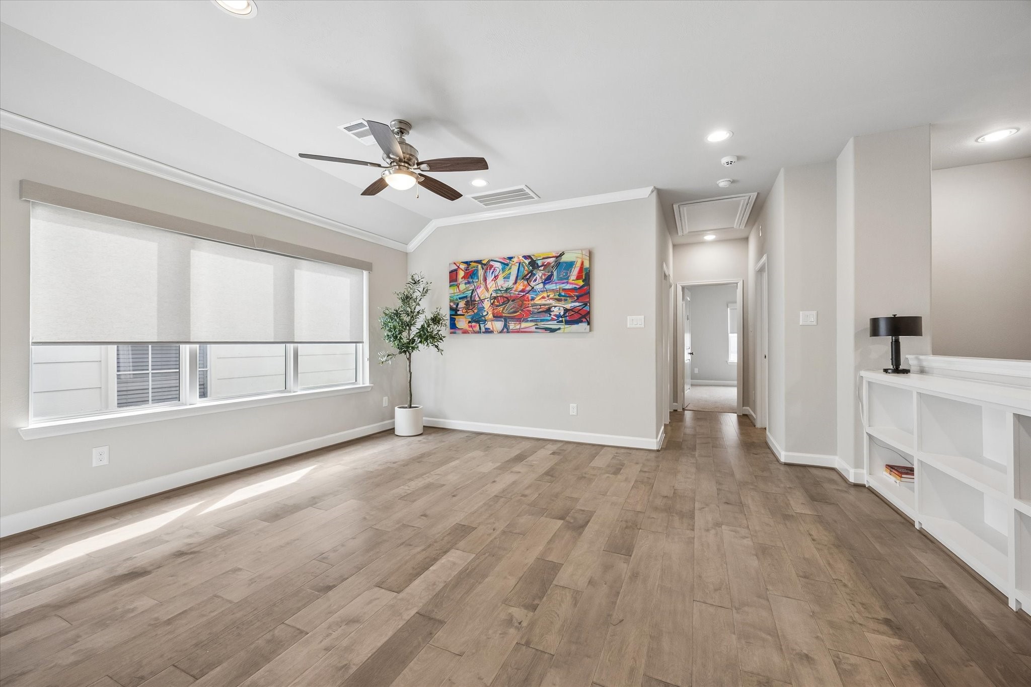 809 Malone Street Houston, TX 77007 - Photo 15 of 26 Upstairs living area with engineered wood flooring and abundant natural light.