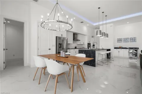 a large kitchen with a table and chairs
