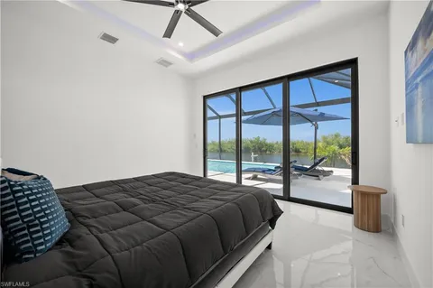 a kitchen with white cabinets and black appliances
