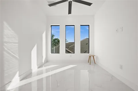 a bed sitting in a bedroom next to a window