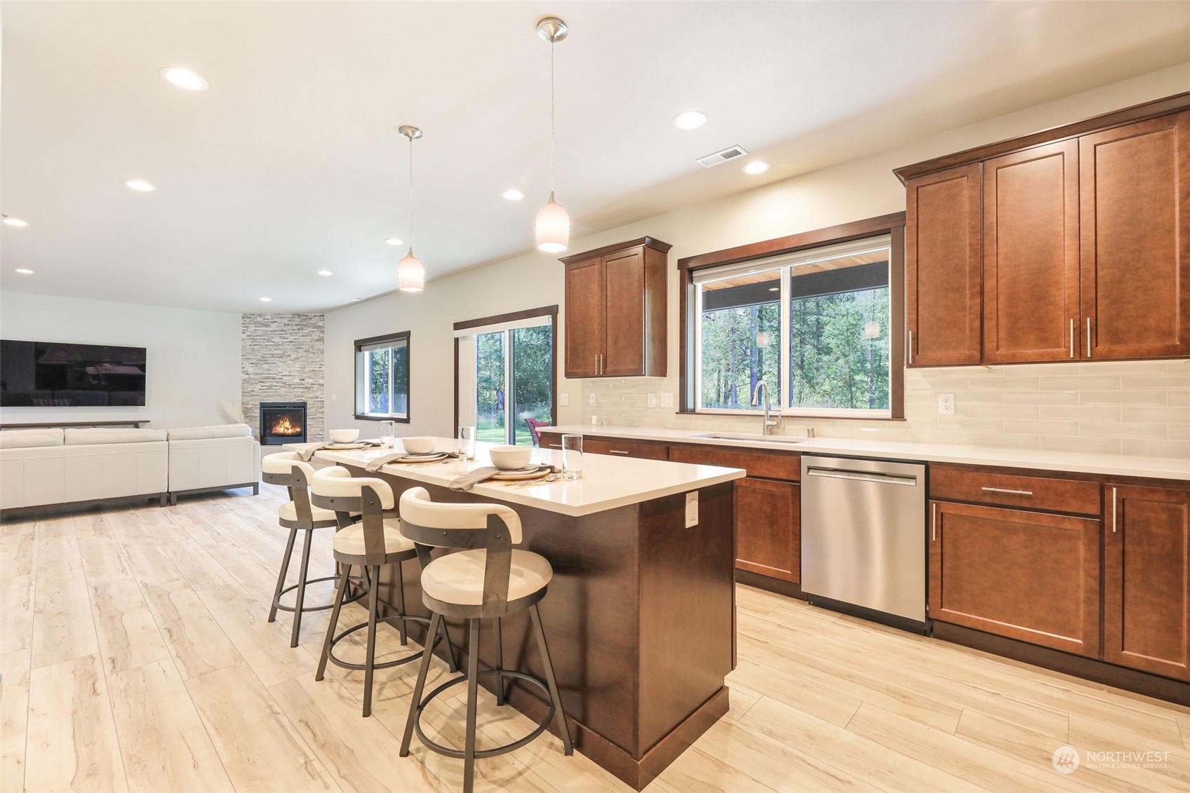 36016 Mann Road Sultan, WA 98294 - Photo 11 of 39 a dining hall with stainless steel appliances granite countertop a stove a sink dishwasher and a microwave with wooden floor