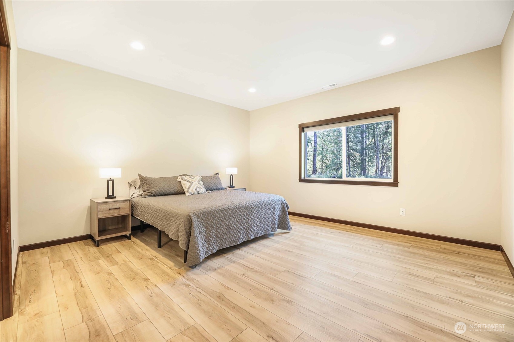 36016 Mann Road Sultan, WA 98294 - Photo 14 of 39 a spacious bedroom with a bed and a wooden floor