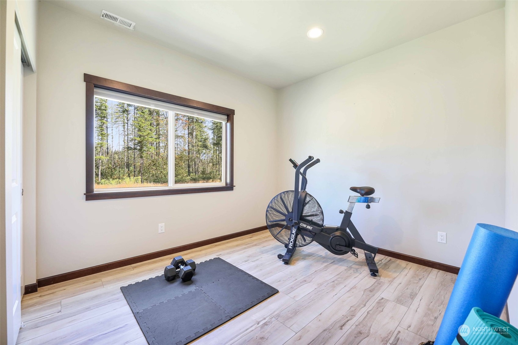 36016 Mann Road Sultan, WA 98294 - Photo 20 of 39 a room with gym equipment on wooden floor