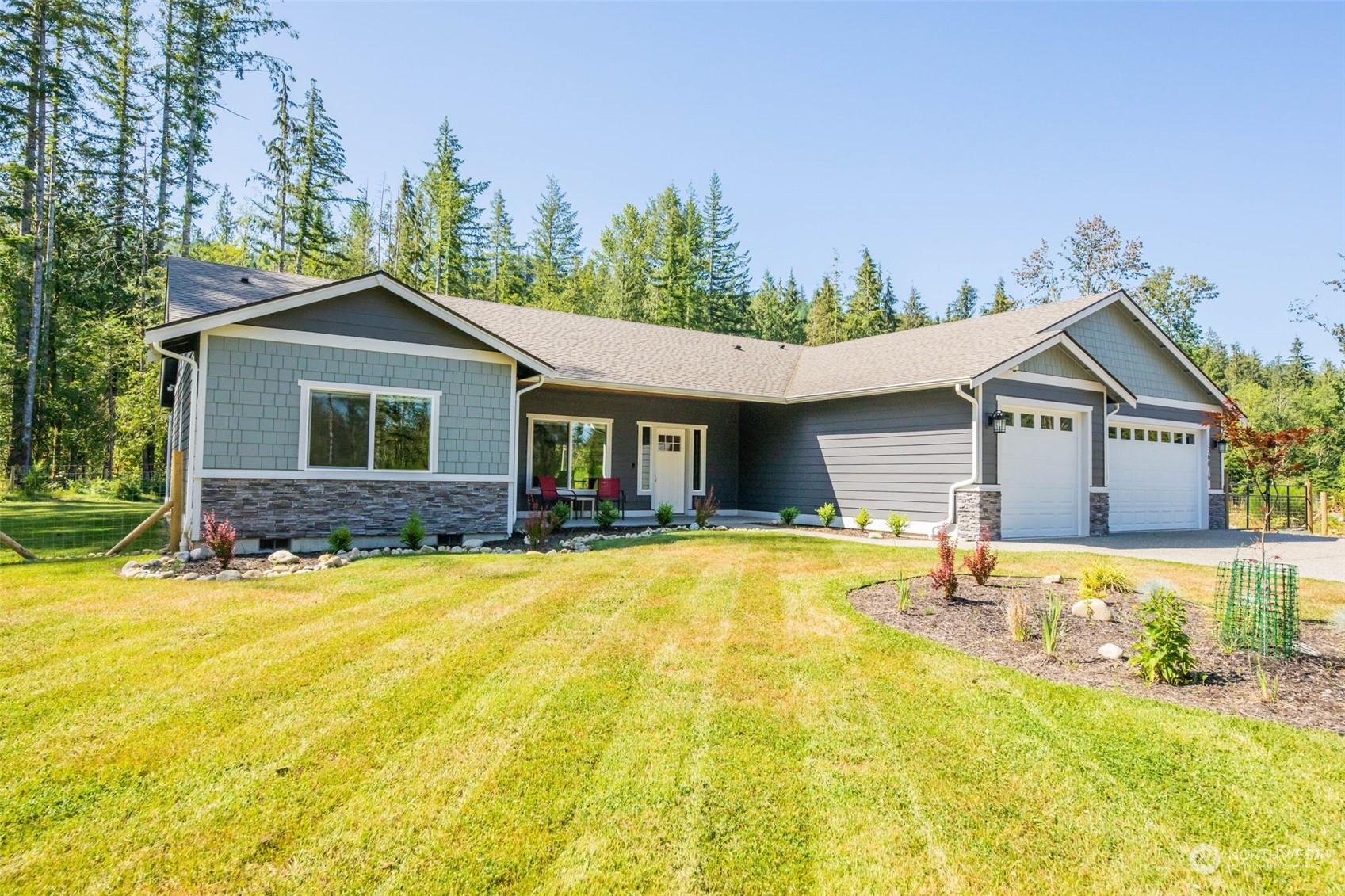 36016 Mann Road Sultan, WA 98294 - Photo 3 of 39 a front view of a house with a yard and garage